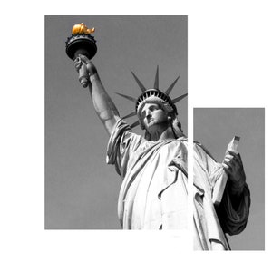 May include: A black and white photo of the Statue of Liberty, with the torch lit in gold.