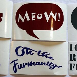 May include: A collection of white stickers with various phrases in bold fonts. Phrases include "OWO WHAT'S THIS?", "MEOW!", "YIP!", "DON'T WORRY BE FURRY", "Oh the Furmanity", and "100% REAL FURRY". A trash can graphic is also present.