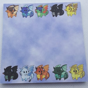 May include: A sheet of blue paper with a border of colorful cartoon dragons. The dragons are in various poses and have different colored scales. The dragons are all facing the same direction.