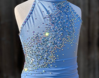 May include: A light blue dance leotard with a high neckline and a design of iridescent rhinestones and lace.