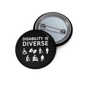 May include: Black button with white text that reads "Disability is Diverse". The button features various disability symbols including a wheelchair, a sign language symbol, a cane, a person walking, a person using a walker, a person using a scooter, and a person using crutches.