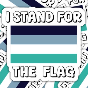 May include: A sticker with a blue, light blue, white, and teal flag design. The sticker says "I stand for the flag".
