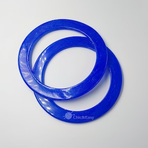 May include: Two blue plastic knitting ring looms, one slightly larger than the other, with a white logo that says "Chic&Easy".