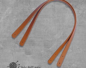 Peut inclure: Deux sangles en cuir marron avec des coutures, pouvant servir de poignée de sac.