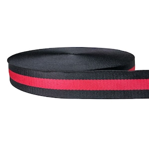 May include: Black webbing with a single red stripe. The webbing is rolled up.
