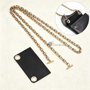 May include: A long gold-toned metal chain with T-bar ends and a rectangular black leather-like patch featuring two gold-toned metal grommets. An inset circular image shows the chain attached to a black bag with gold-toned hardware and Chic&Easy text.