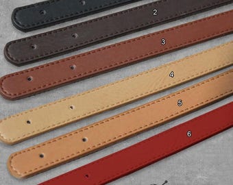 May include: Six leather straps in different colors, numbered 1 through 6. The straps are all the same size and have a stitched edge.