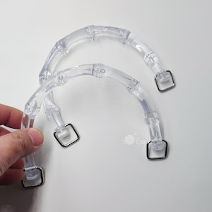 May include: Two clear plastic handles with metal rings. The handles are designed to look like bamboo.