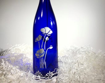 Elegant and unique, blue and white hand painted wine bottle instantly adds style and class to any room or occasion (multiple flowers)