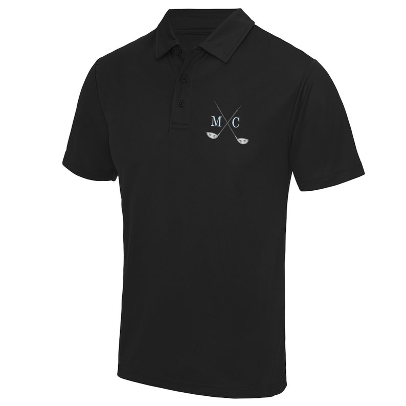 May include: Black polo shirt with a white embroidered design of crossed golf clubs and the letters "M C".