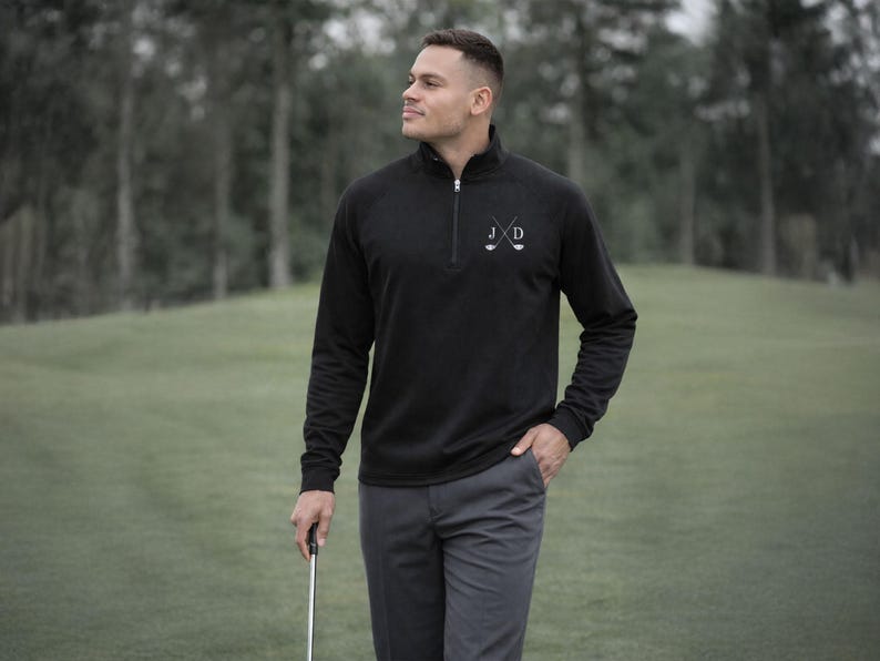 Golfer Wearing Black Quarter Zip Pullover Sweatshirt with Embroidered Initials on the golf course later in the day