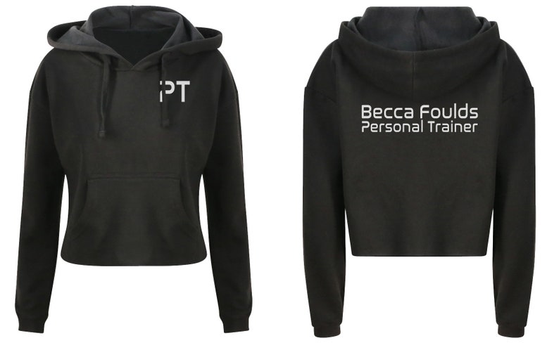 May include: Black cropped hoodie with a white "PT" logo on the front and "Becca Foulds Personal Trainer" on the back.