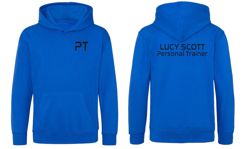 May include: A royal blue hooded sweatshirt with the text "PT" on the front and "LUCY SCOTT Personal Trainer" on the back.