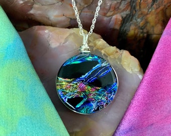 Laguna ~ Dichroic Glass Circle Pendant in Blue with Flashes of Rainbow Colors on Black