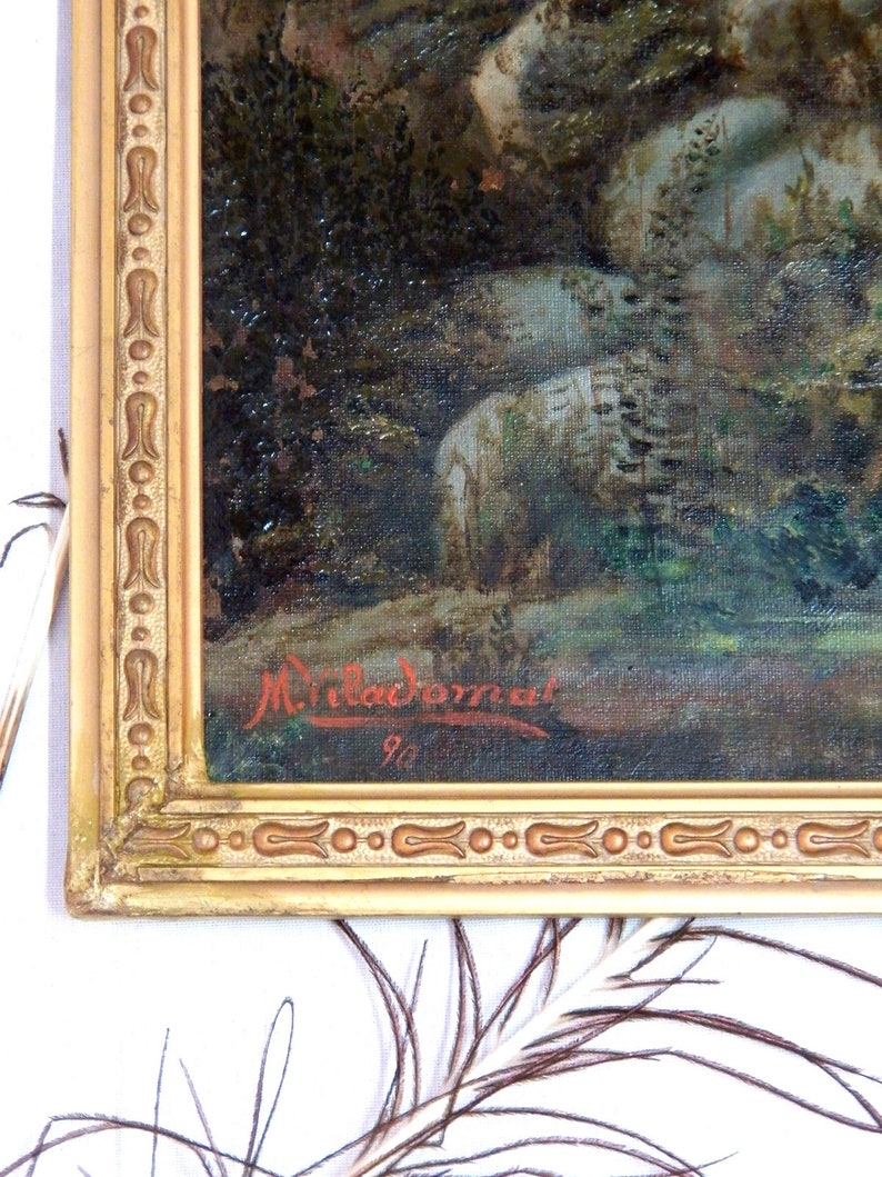 May include: A close-up of a painting in a gold frame. The painting is of a forest scene with a signature in the bottom right corner that reads "Miladoman 90".