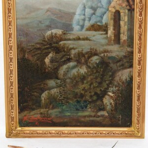 May include: A framed oil painting depicting a landscape scene with a stone building and a mountain in the background. The painting is signed "M. Macdonald" in the lower right corner.