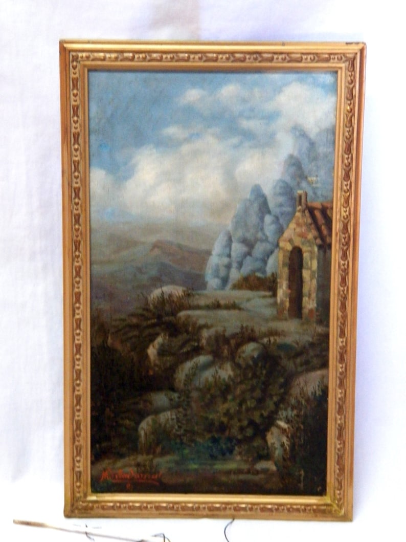 May include: A framed oil painting depicting a landscape with a stone building in the foreground. The building has a rounded archway and a roof with a chimney. The background features rolling hills and a cloudy sky.