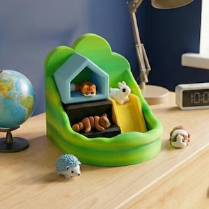 May include: A colourful toy playset featuring a green and yellow structure with a house, slide, and steps. It includes miniature animal figurines: a tiger, rabbit, and squirrel. Additional figurines include a hedgehog and a guinea pig. A globe and digital clock are in the background.