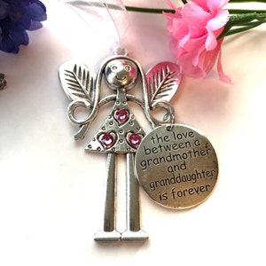May include: Silver angel figurine with pink glitter hearts and a charm that reads "The love between a grandmother and granddaughter is forever".