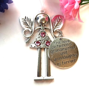 May include: Silver angel figurine with pink glitter hearts and a charm that reads "the love between a grandmother and granddaughter is forever".