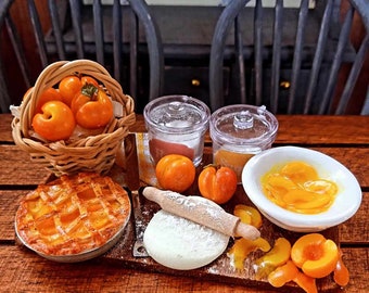 May include: A miniature peach pie with a lattice crust, a bowl of sliced peaches, a rolling pin, and a ball of dough on a wooden cutting board. There are also several whole peaches and two glass jars with lids.