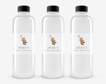May include: Three clear plastic water bottles with labels that say "alice's first birthday" and feature a cartoon brown bear holding a pink balloon.