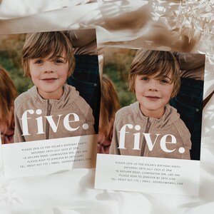 May include: Two white cards with a photo of a young boy on each. The text "five." is printed in large white letters on each card. The cards are on a white and beige fabric background.