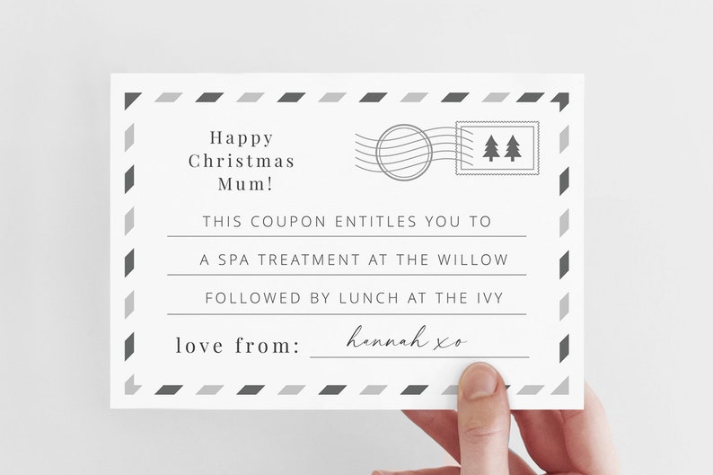 May include: A white gift certificate with a black and gray border. The text reads "Happy Christmas Mum! This coupon entitles you to a spa treatment at the Willow followed by lunch at the Ivy. Love from: hennah xo"