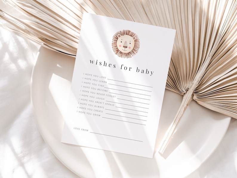 May include: A white card with the text "wishes for baby" and a list of wishes for a baby, including "I hope you love", "I hope you learn", "I hope you find", "I hope you become", "I hope you never forget", "I hope you laugh", "I hope you aren't afraid", "I hope you always", "I hope you create", and "I hope you grow". The card also has a watercolor illustration of a lion's head with a pink nose and brown mane.