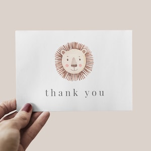 May include: A white card with a brown lion face illustration and the text "thank you".