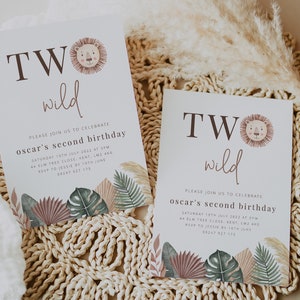 May include: Two invitations with a jungle theme for a child's second birthday. The invitations are white with brown text that says "TWO wild". The invitations feature a cartoon lion and jungle leaves.