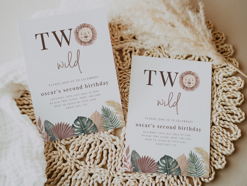 May include: Two invitations with a jungle theme for a child's second birthday. The invitations are white with brown text that says "TWO wild". The invitations feature a cartoon lion and jungle leaves.