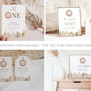 May include: A set of printable party decorations featuring a lion with a wild one theme. The set includes a birthday invitation, a thank you tag, a time capsule sign, and a custom sign. The decorations are in a neutral color palette with brown, beige, and gold accents.