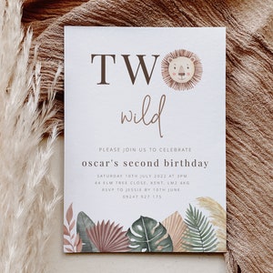 May include: A white invitation card with the text "TWO wild" in brown lettering. The card is decorated with a lion head illustration and tropical leaves. The text "Please join us to celebrate oscar's second birthday" is printed in brown lettering. The invitation includes the date, time, address, and RSVP information.