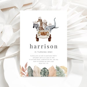May include: A white invitation card with a jungle theme. The card features a cartoon illustration of a jeep with a giraffe, zebra, leopard, and elephant riding in it. The text on the card reads "harrison is turning one!" and includes details for a birthday party.