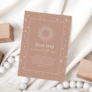 May include: A light brown invitation with a white sun and stars design. The text reads "first trip around the sun" and includes details for a birthday party.