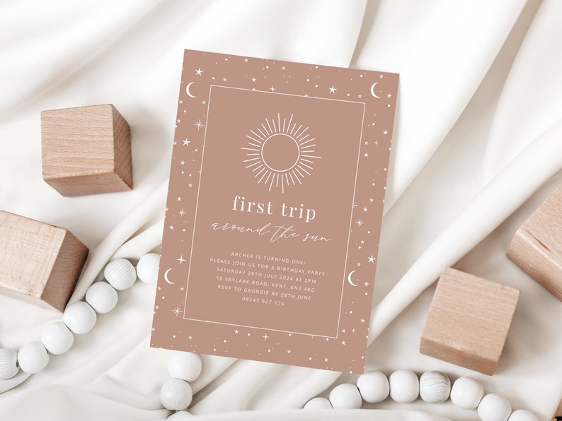 May include: A light brown invitation with a white sun and stars design. The text reads "first trip around the sun" and includes details for a birthday party.