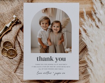 May include: A thank you card with a photo of two children, a boy and a girl, standing together. The card has a white background with a gray arch at the top. The text "thank you" is in bold, black letters. The text "THANK YOU FOR JOINING US AT OUR PARTY! IT WAS SUCH A FUN DAY AND WE LOVED BEING WITH ALL OF OUR FRIENDS AND FAMILY. love willow + jasper xo" is in smaller, gray letters.