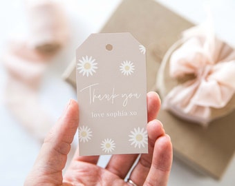 May include: A light brown gift tag with a white daisy pattern and the text "Thank you love sophia xo".
