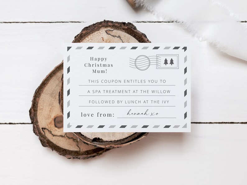 May include: A white gift certificate with black and gray accents. The text reads "Happy Christmas Mum! This coupon entitles you to a spa treatment at The Willow followed by lunch at The Ivy. Love from: Hannah xo"
