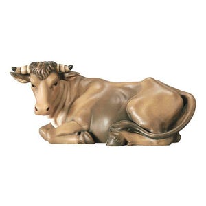 May include: A brown wooden cow figurine lying down with its head turned to the side. The cow has white horns and a brown and white face.