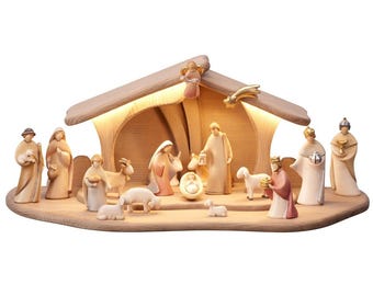 May include: A wooden nativity scene with a light-up stable and figures of Mary, Joseph, baby Jesus, shepherds, angels, and animals. The scene is illuminated with warm white LED lights.