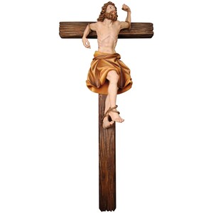 Może przedstawiać: Drewniana rzeźba przedstawiająca osobę na krzyżu. Osoba jest przedstawiona z tkaniną owiniętą wokół talii i wyciągniętymi ramionami. Rzeźba jest pomalowana w odcieniach brązu i beżu.