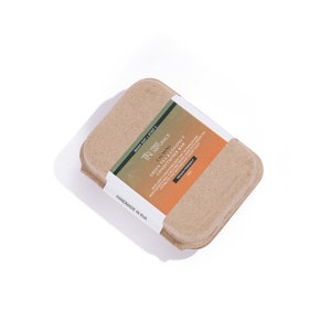 May include: A brown cardboard box with a white label that reads "TN Naturals Calming Green Tea & Coconut Conditioner Bar". The label also says "Wash Day Step 3", "Vegan Friendly", and "Handmade in RVA".