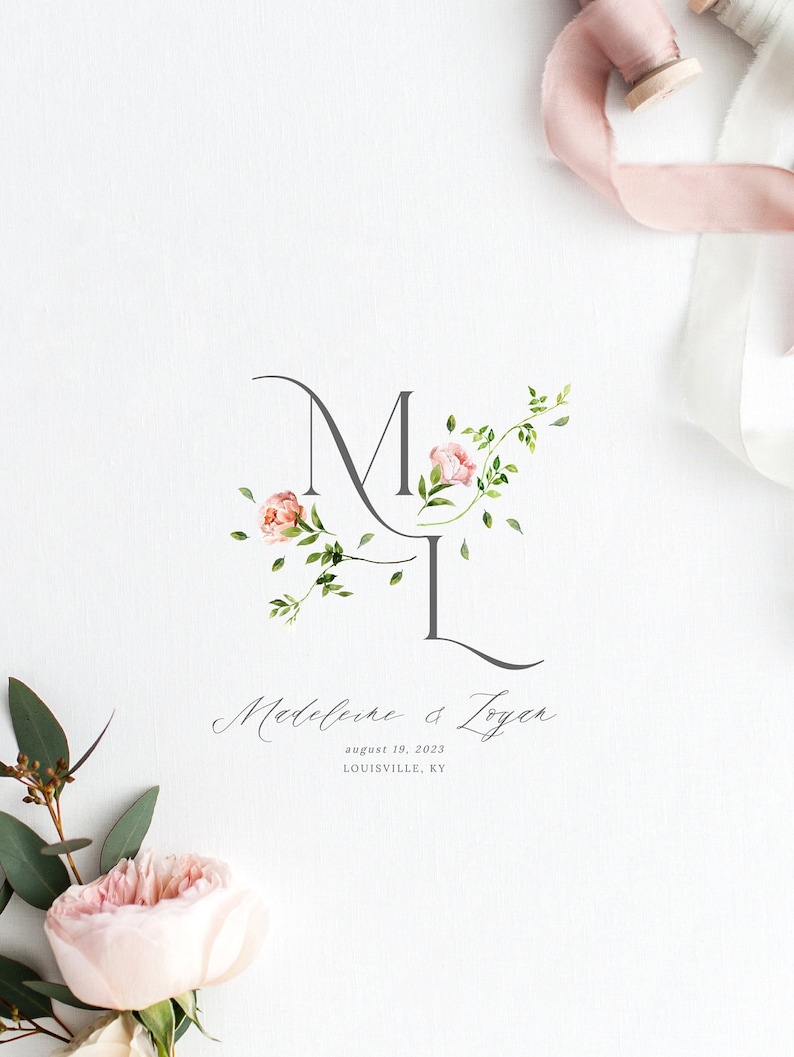 May include: A wedding invitation with a floral monogram of the letters "M" and "L" in gray script. The letters are intertwined with pink flowers and green leaves. The text "Madeleine & Loyer" is written in cursive below the monogram, followed by the date "August 19, 2023" and the location "LOUISVILLE, KY".