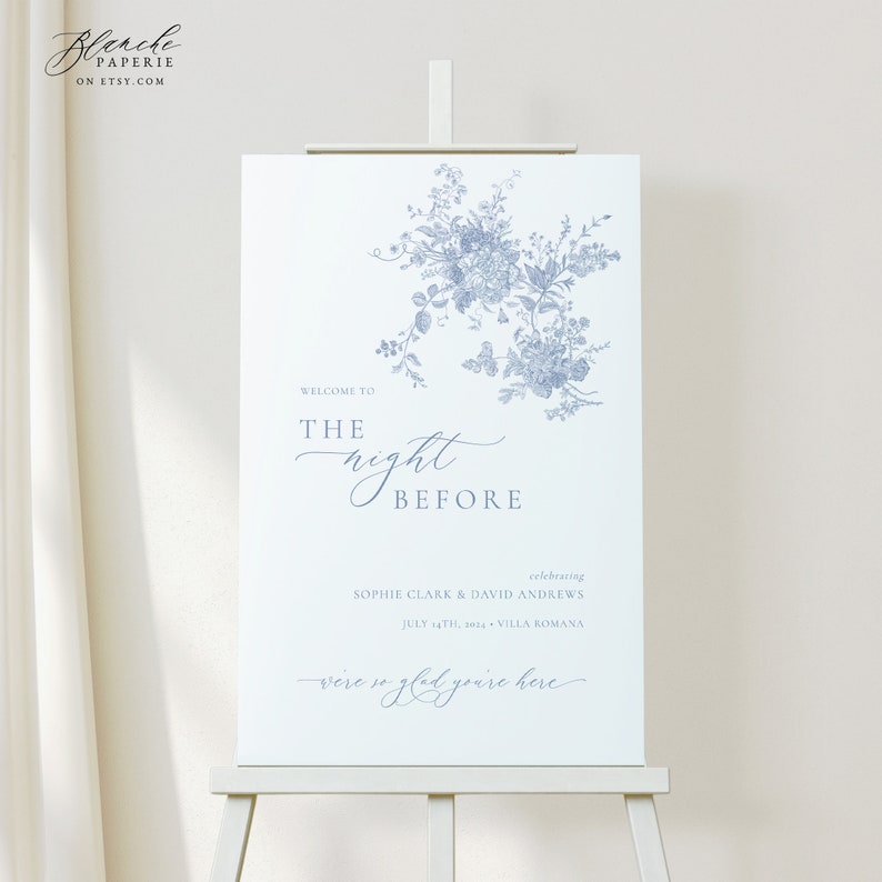 May include: A white welcome sign with blue floral illustrations and the text "Welcome to the night before celebrating Sophie Clark & David Andrews July 14th, 2023 Villa Romana were so glad you're here".