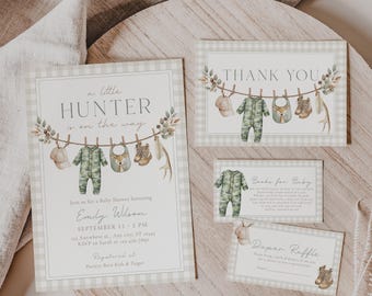 May include: Baby shower invitation set with a woodland theme. The invitation features the text "A Little Hunter is on the Way" and includes a matching thank you card, book request card, and diaper raffle card. The design includes camouflage onesies and baby boots.