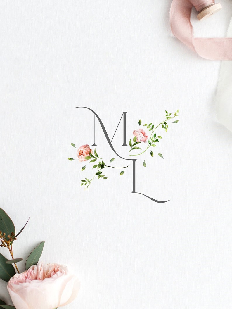 May include: A floral monogram with the letters "M" and "L" in a gray script font. The letters are adorned with pink flowers and green leaves.