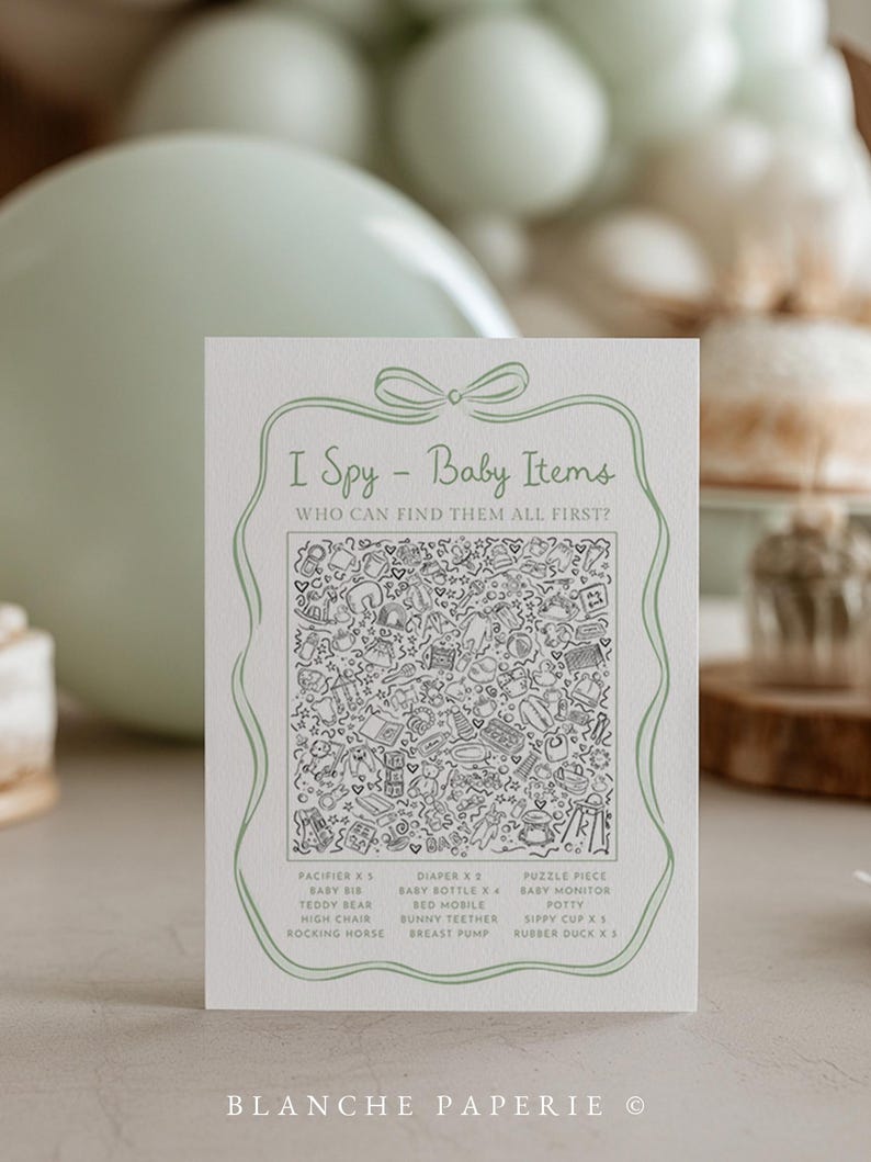 May include: A baby shower game card with the text "I Spy - Baby Items". The card features a detailed black and white illustration of baby-related objects. The card includes a list of items to find, such as pacifiers, diapers, and a rocking horse.