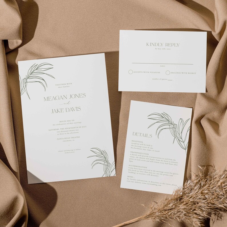 May include: A set of wedding stationery featuring a minimalist design. The invitation, reply card, and details card are white with green botanical illustrations and text. The invitation reads "Meagan Jones and Jake Davis".